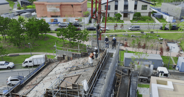 Construction workers pouring concrete