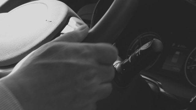 Hands gripping a steering wheel