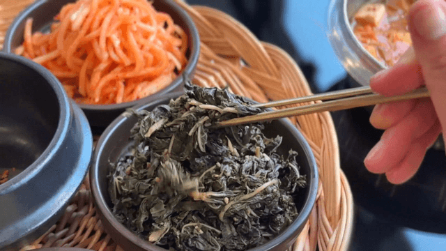 Chopsticks holding seasoned castor-oil plant