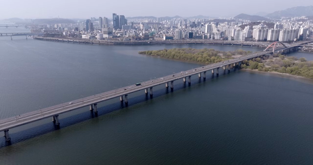 A bridge over a river with a city skyline