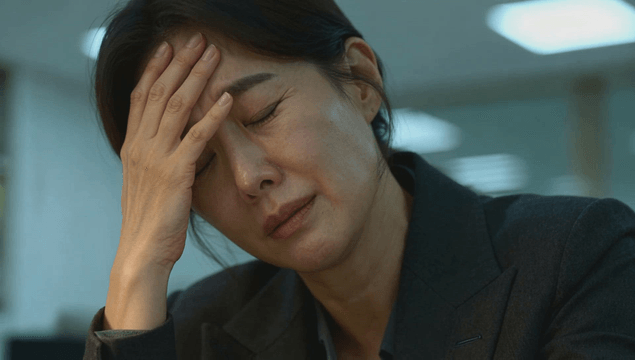 Stressed office worker holding her head