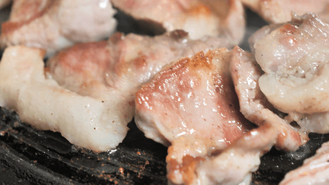 Grilling pork on a hot grill