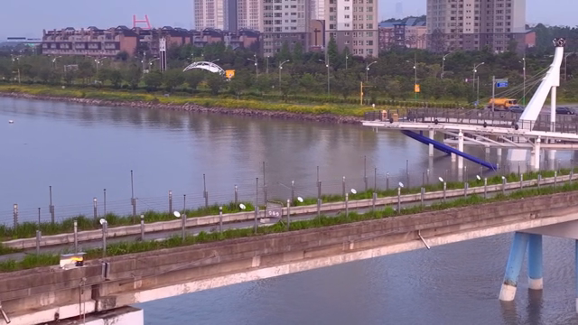 A riverside view with city buildings