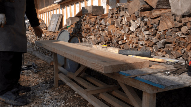 Person working with wood outdoors