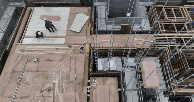 Construction site with workers and materials