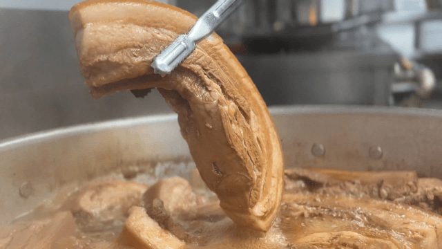 napa wraps with pork boiling in a large pot