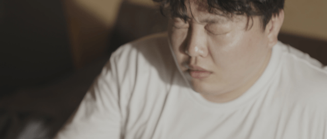 Person waking up in a dimly lit room