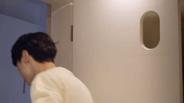 Couple playfully brushing teeth together in bathroom