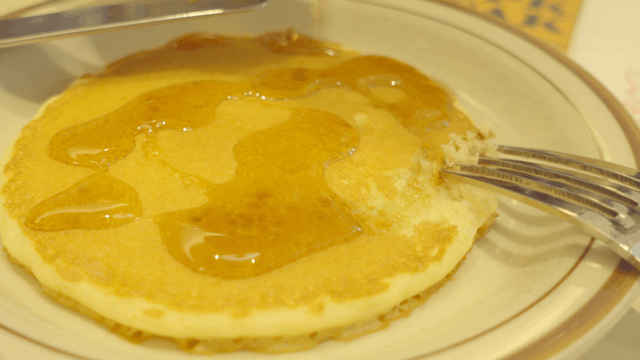 Pancake with syrup being poured