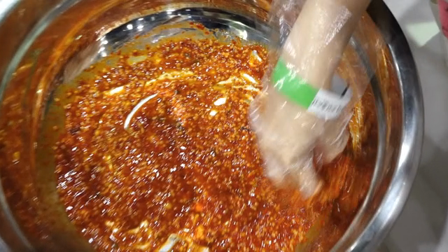Mixing kimchi seasoning in a bowl