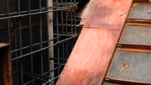 Worker at a construction site with metal bars