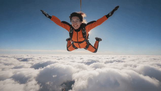 Skydiver enjoying freefall above the clouds