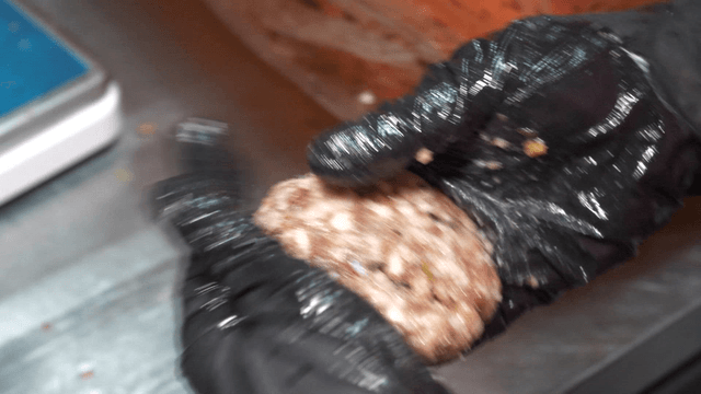 Hands preparing grilled short rib patties in the kitchen