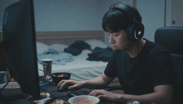 Young man focused on gaming in room
