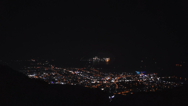 City illuminated at night from a distance