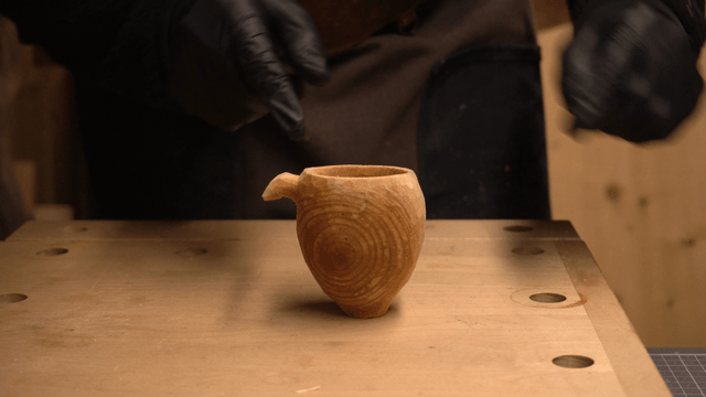 Handcrafted wooden cup on a workbench