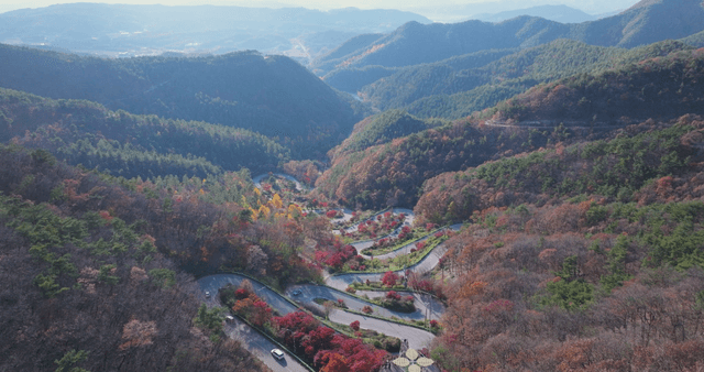 Winding mountain road with autumn foliage