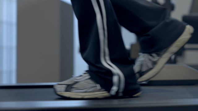 Person jogging on a treadmill indoors