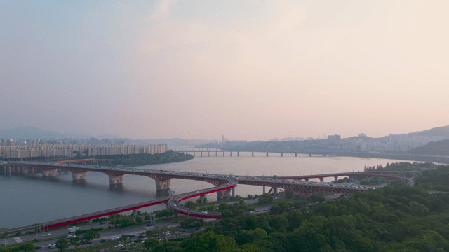 Han River with busy bridge intersection filled with cars