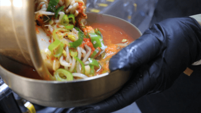 Spicy cod soup served in brass bowl