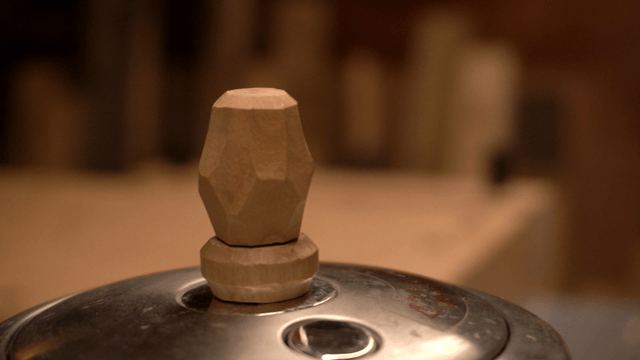 Unique handcrafted wooden handle on metal lid