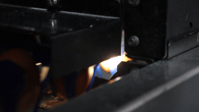 Factory machine inspecting eggs with fast scanning light