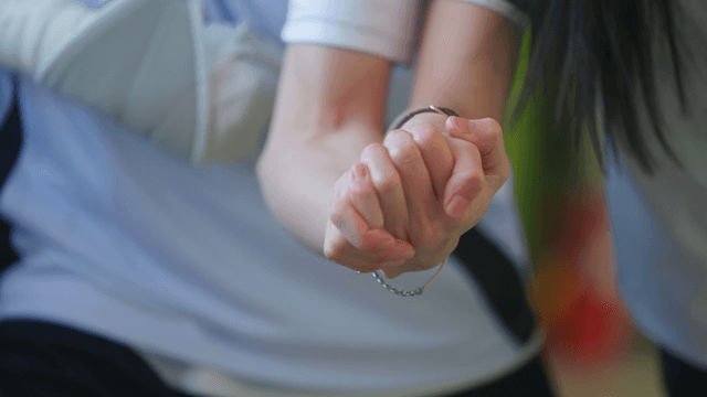 Two people holding hands closely