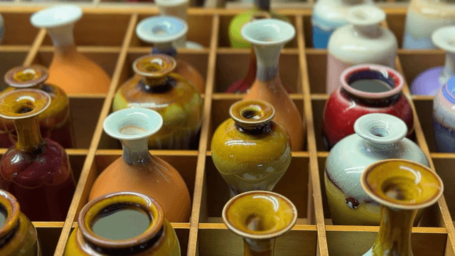 Colorful ceramic vases displayed in a grid