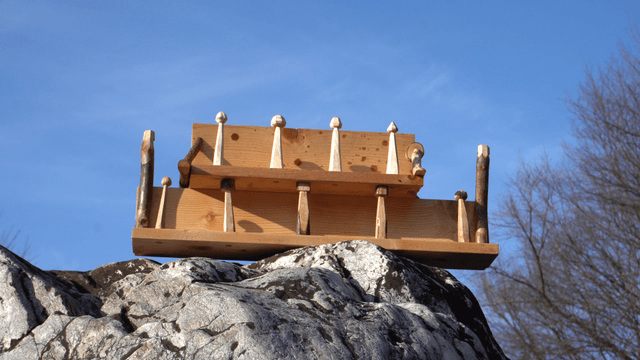 Wooden shelf on rocks under the blue sky