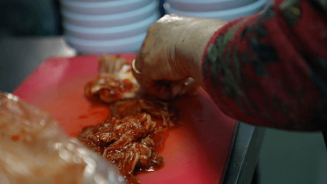 Kimchi being prepared on a cutting board