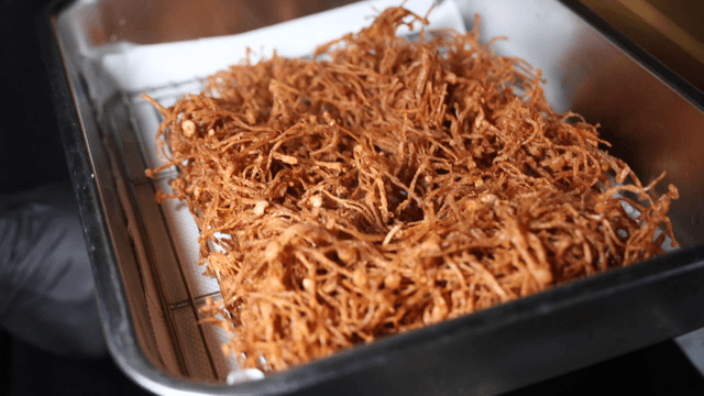 Tray of freshly fried crispy enoki mushrooms