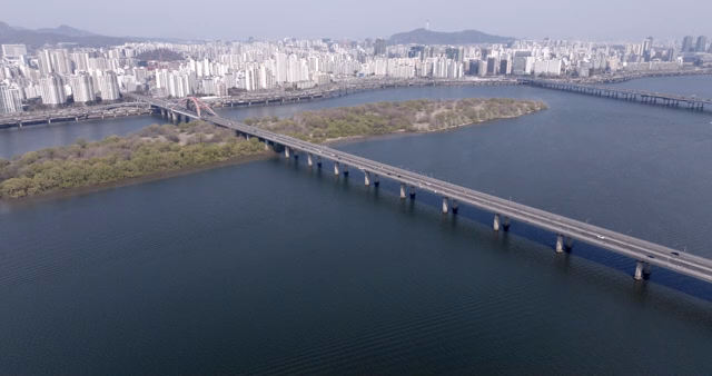 A bridge over a river with a city skyline