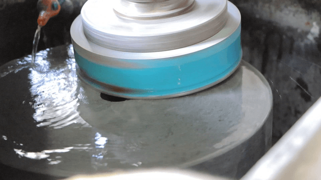 Machine polishing the surface of basalt