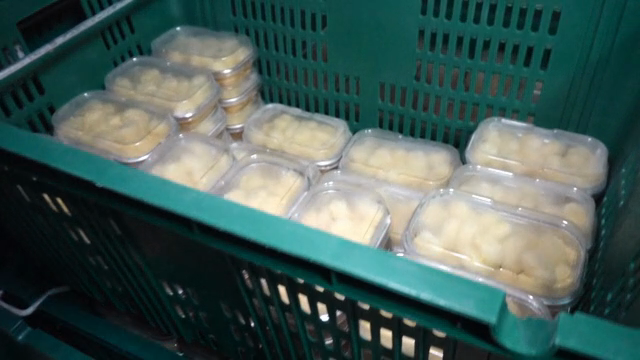 Plastic containers filled with food in a crate