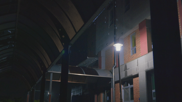 Rain falling at a school with streetlights at night