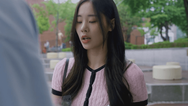 Sad woman giving flowers in a park