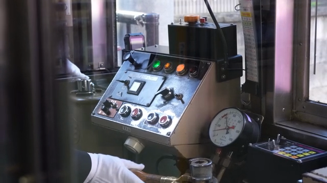 Japanese train operator adjusting control panel