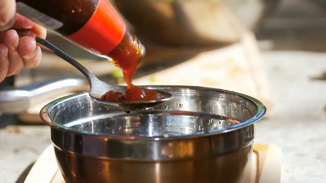 OysterSauce being poured into a bowl