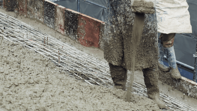 Worker pouring concrete on a construction site