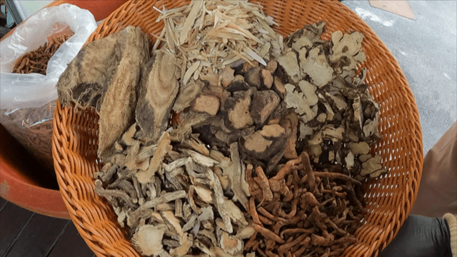 Various dried medicinal herbs in a basket