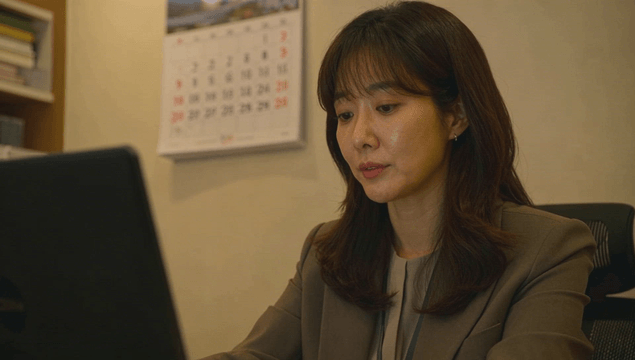 Office worker woman working on laptop