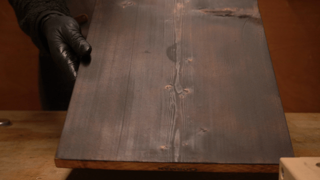 Artisan working on a black wooden board