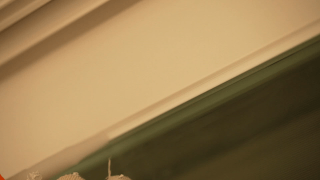 Worker applying sealant to window frame