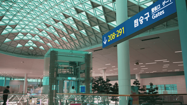 Modern airport terminal with gate signs