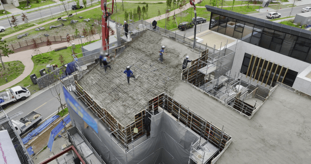Workers pouring concrete on a building site