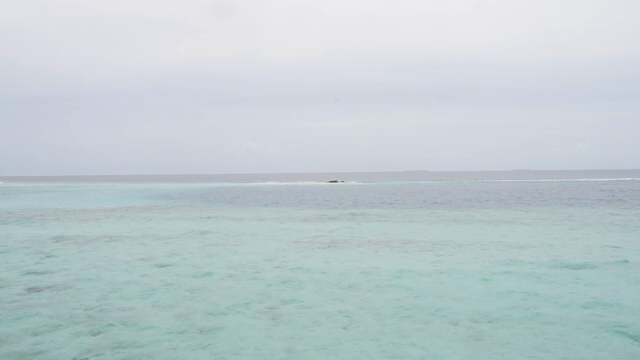 Calm sea with gentle waves under a cloudy sky
