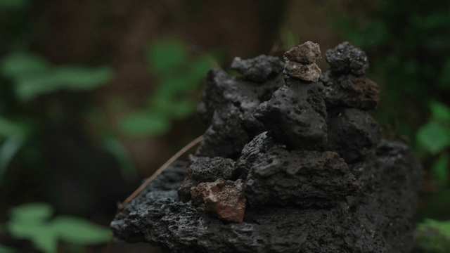 Stacked basalt stones in dense forest