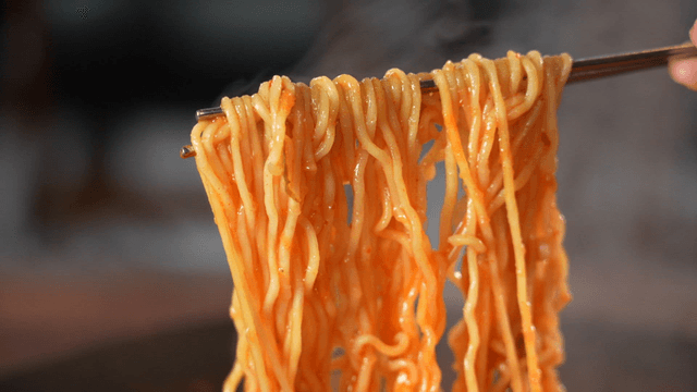 Picked-up ramen from budaejjigae with chopsticks