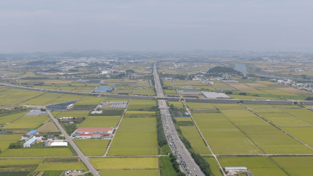Expansive farmland with a highway