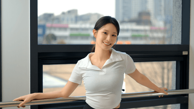 Young woman smiling while facing the window